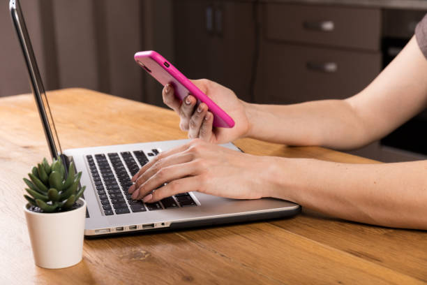 istock Young woman working on computer at table in office, closeup. Banner design 1326632398
