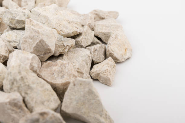 istock Gray small rocks ground texture isolated on white background. Small road stone. 1326632756