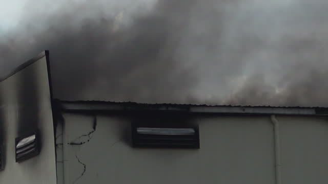 Black Smoke Rises On Old Building