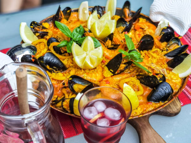 istock Paella home made decorated with shrimp, mussels, lemon and basilic. 1326635941