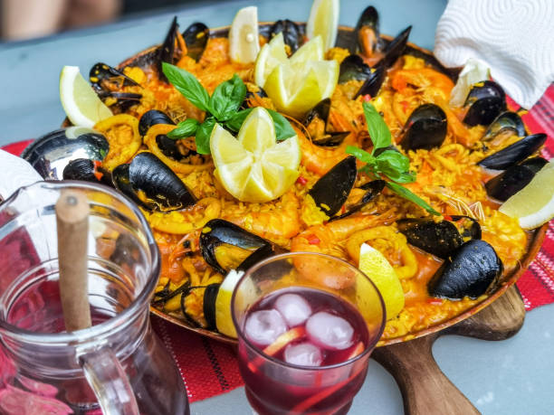 istock Paella home made decorated with shrimp, mussels, lemon and basilic. 1326635977