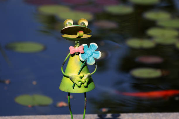 Decorative frog in the garden by the pond.