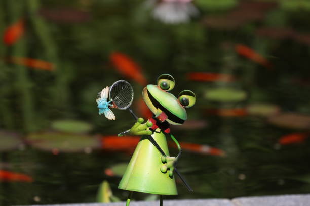 Decorative frog in the garden by the pond.