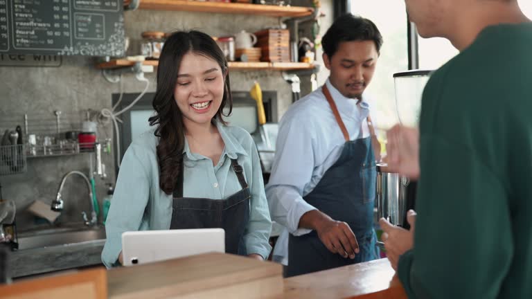 Asian business owner taking an orders from customer