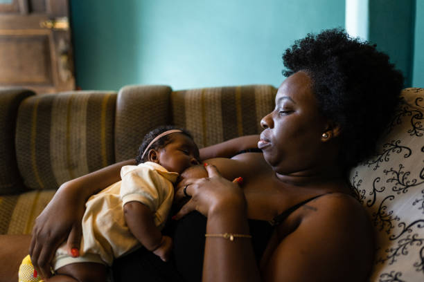 istock Mother breastfeeding lying on the couch 1326638540