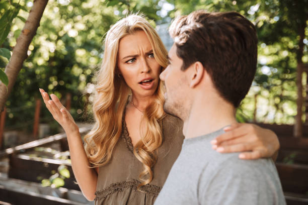 istock Confused young couple sitting together and arguing 1326639584