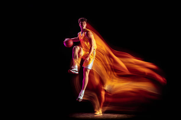 istock Young Caucasian basketball player training isolated on black background in mixed neon lights. 1326640664