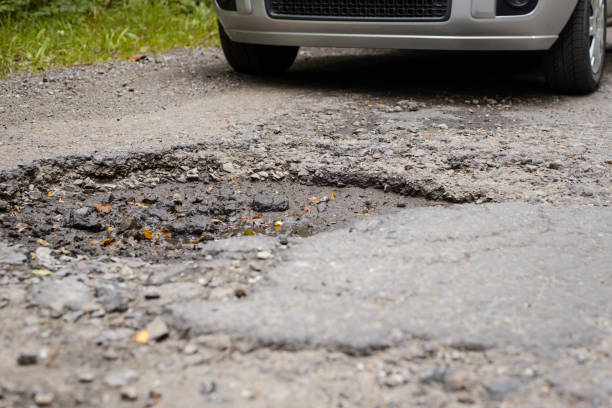 istock Car approaching big pothole in the countryside road 1326641792