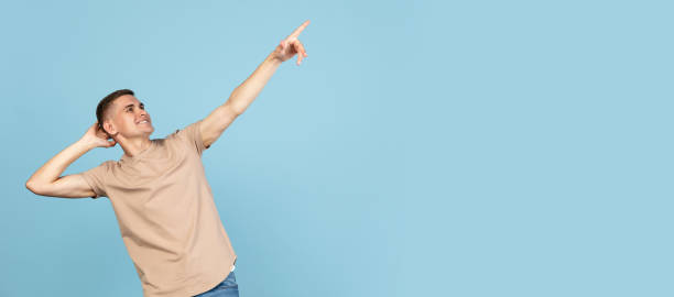 istock Portrait of young Caucasian man posing isolated over blue studio background with copyspace for ad. Concept of human emotions 1326642390