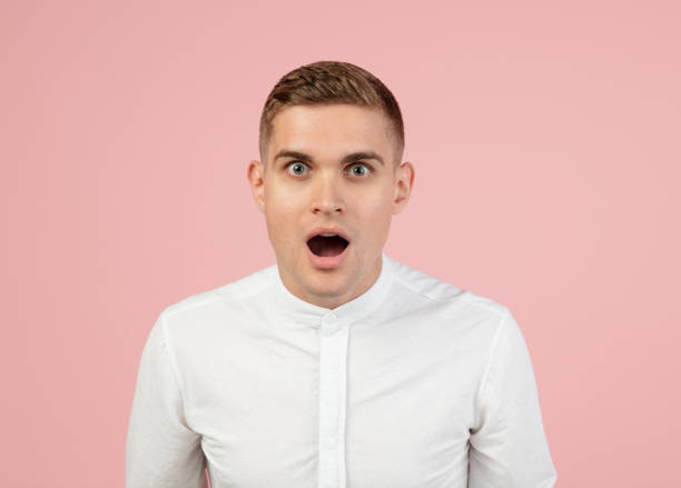 istock Portrait of young Caucasian man posing isolated over pink studio background with copyspace for ad. Concept of human emotions 1326642424