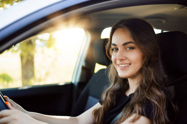 istock Attractive young girl driver in new car 1326643335