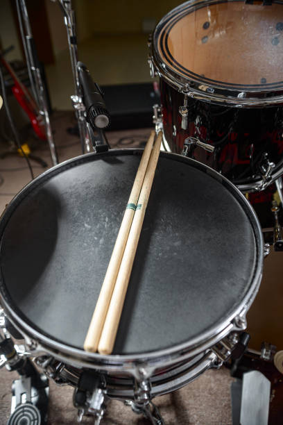 istock The drum kit is on the stage at the rehearsal base. Drumsticks is on a drum set. 1326644286