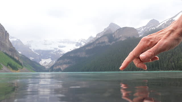 Scenic view across Lake Louise during rain storm