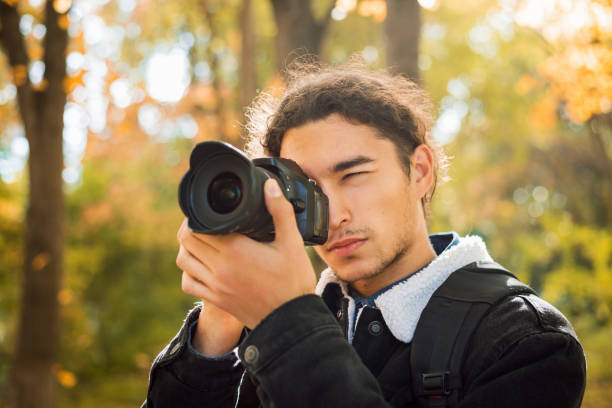 istock Professional photographer shooting fall landscapes in forest 1326644619