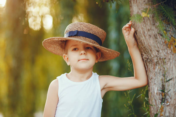 istock Cute little boy in a hat spend time in a summer park 1326644724