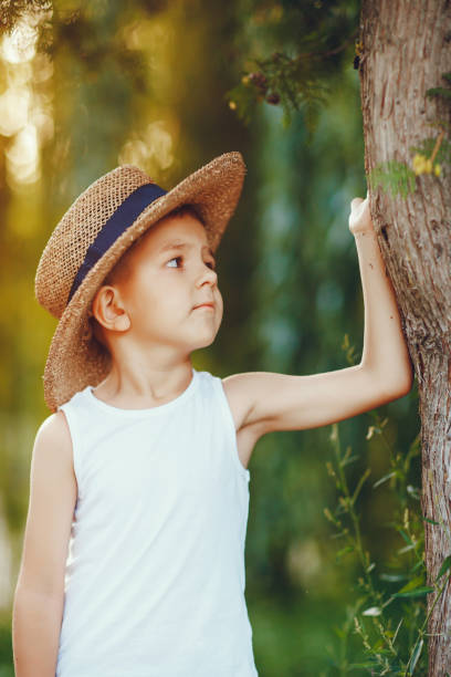 istock Cute little boy in a hat spend time in a summer park 1326644727