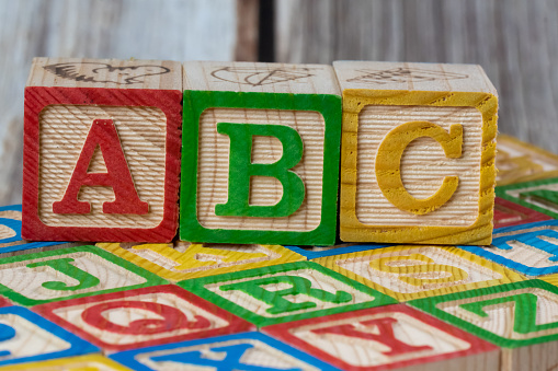 wooden alphabet letters on the red background