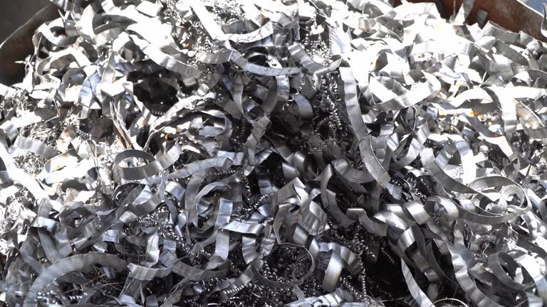 Steel scrap materials recycling. Aluminum chip waste after machining metal parts on a cnc lathe