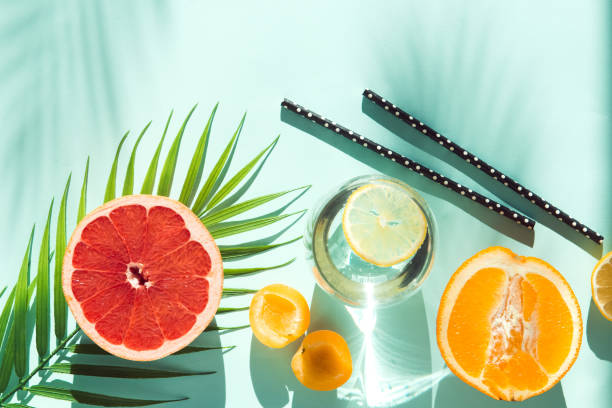 istock fresh summer fruit and water galss with paper tubes on blue background flat lay 1326648218