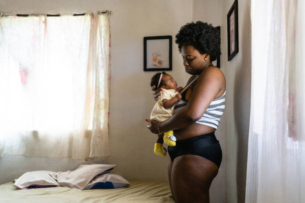 istock Mother in panties holding baby 1326649231