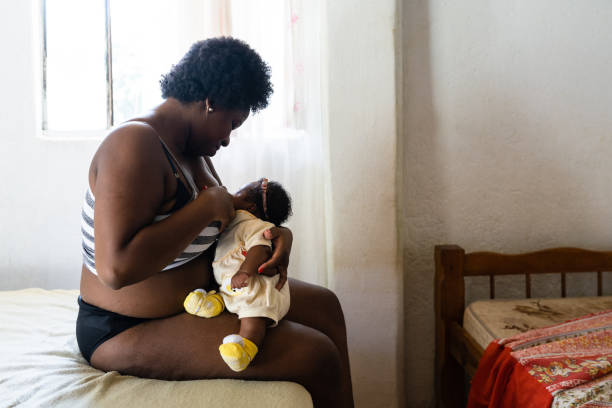 istock Mother breastfeeding daughter in bed 1326649247
