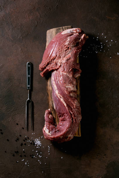 istock Fresh whole raw beef tenderloin on wooden board 1326649393