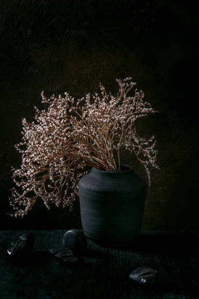 istock Black ceramic vase on black wooden table 1326649506