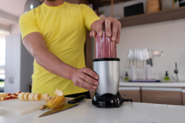 istock Close-up on a man making a healthy smoothie for breakfast 1326651928