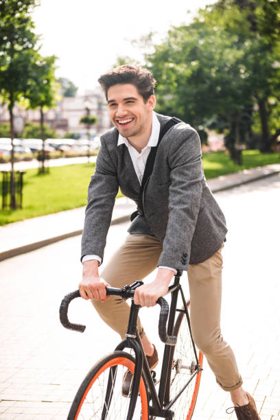 istock Cheerful young businessman riding on a bicycle 1326654443