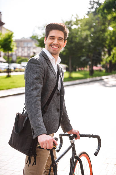 istock Happy young businessman riding on a bicycle 1326654827