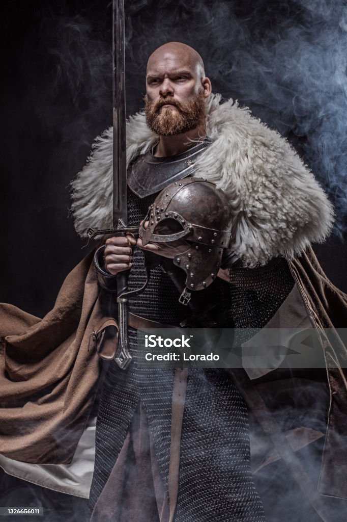 Weapon wielding redhead viking warrior in studio shot Odin - God Stock Photo