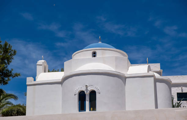 istock White orthodox greek church on clear blue sky background. 1326660404