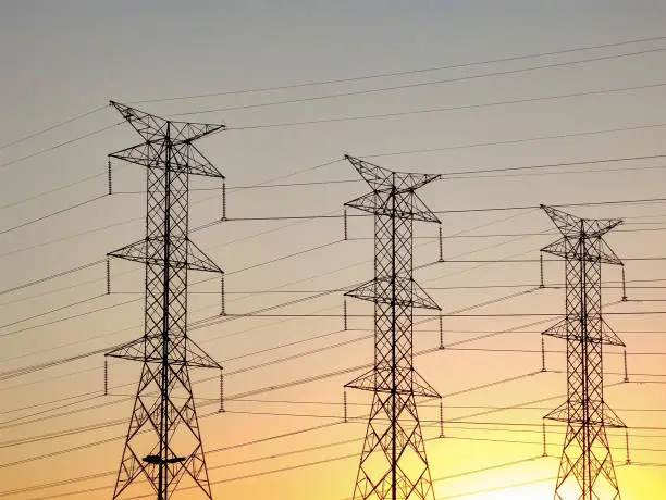 Background of the high-voltage tower in the sunset in skyline.