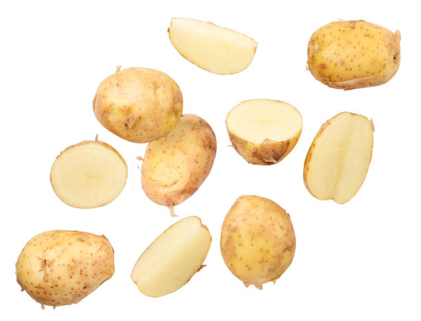 istock Young unpeeled potatoes whole and pieces fly on a white background. Isolated 1326666736