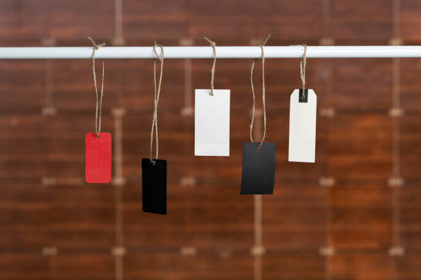 istock simple empty blank isolated price tag label hang on the rope, mockup template for text design. 1326668963