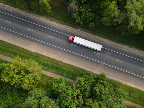 White Truck with Cargo Semi Trailer Moving on Summer Road. Aerial Top View