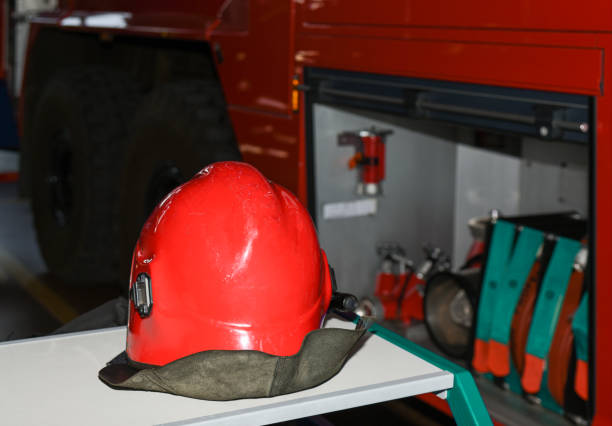 istock Red fireman helmet near a fire truck 1326670791