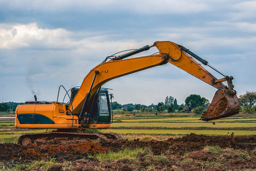 backhoe or excavator working on land of countryside