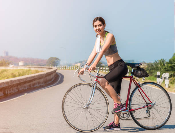 istock Beautiful Asian female exercise by bicycle 1326671099