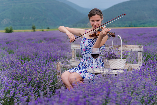Attractive woman - violinist in lavender field