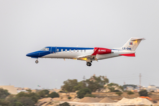 Luqa, Malta - June 30, 2021: Luxembourg Air Ambulance Learjet 45XR (Reg.: LX-ONE) landing after sunset.