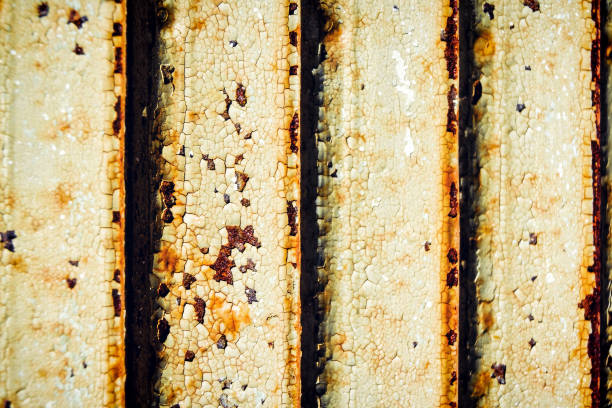 Macro closeup of peeling rusty rust metal white green door abstract background