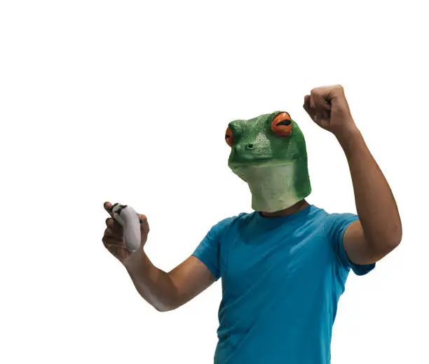 man with a frog animal mask on his head effusive about winning a ps4 game with white background and copy space