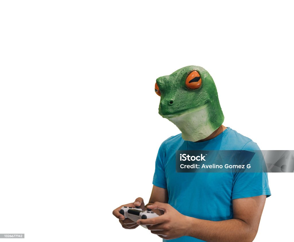 man with an animal mask of a frog on his head with a ps4 console controller to play games with copy space and a white background Achievement Stock Photo