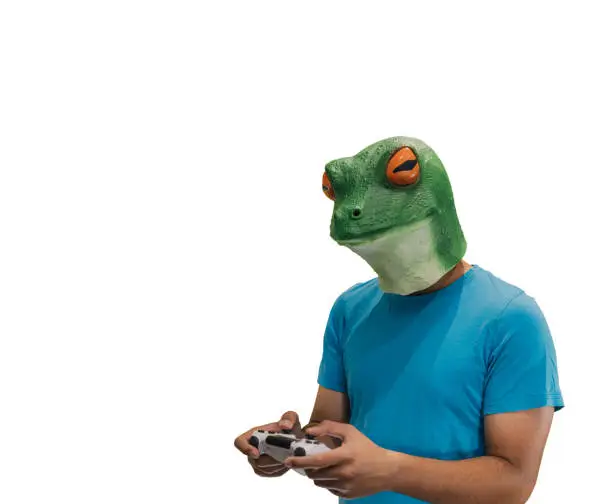 man with an animal mask of a frog on his head with a ps4 console controller to play games with copy space and a white background