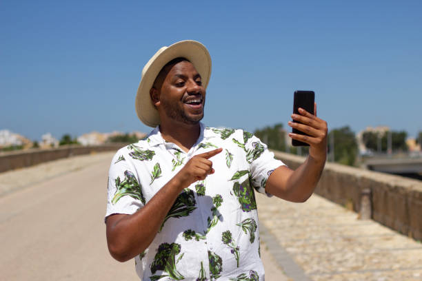 istock Black guy talks on the phone in the street 1326677420