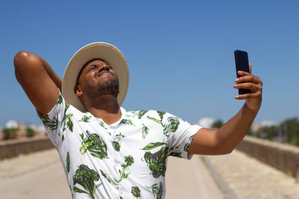 istock Black guy talks on the phone in the street 1326677950
