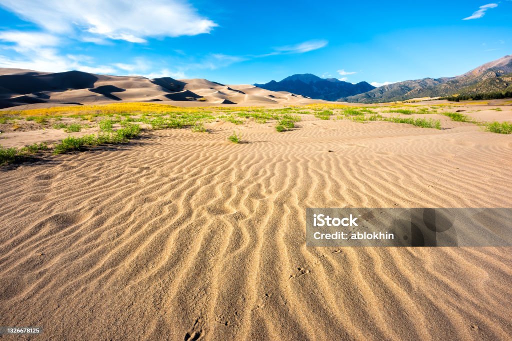 Great Sand Dunes National Park and Preserve in Colorado in autumn fall season wide angle view of landscape and blue sky Great Sand Dunes National Park Stock Photo