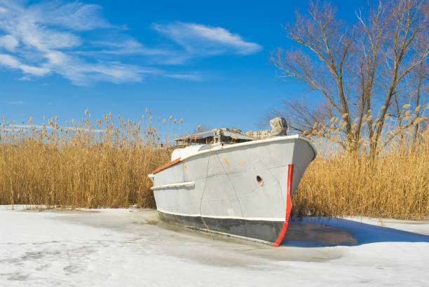 An old motor launch at early spring day on a rushy river.