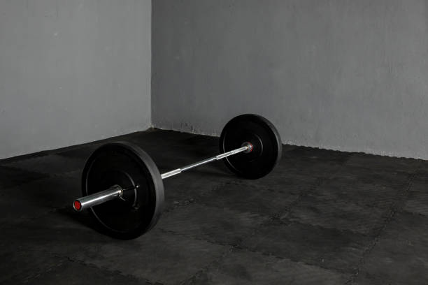istock Olympic bar with weight plates in gym 1326679346